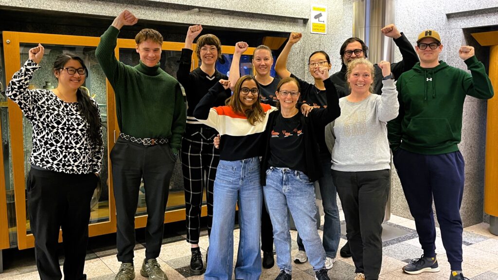 union delegates standing together fists in the air for solidarity